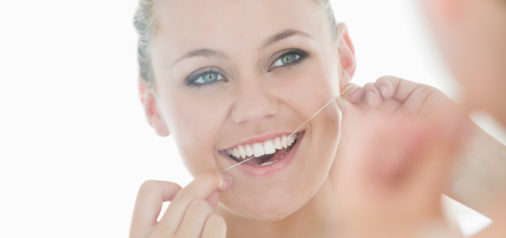 Woman Flossing Teeth