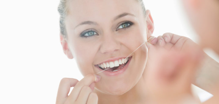 Woman Flossing Teeth